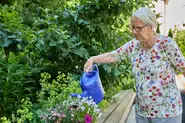 Senioren benötigen eine wichtige Aufgabe im Alltag. Hierzu kann das tägliche Blumengießen auf der Terrasse des Pflegeheims Am Mühlbach gehören.